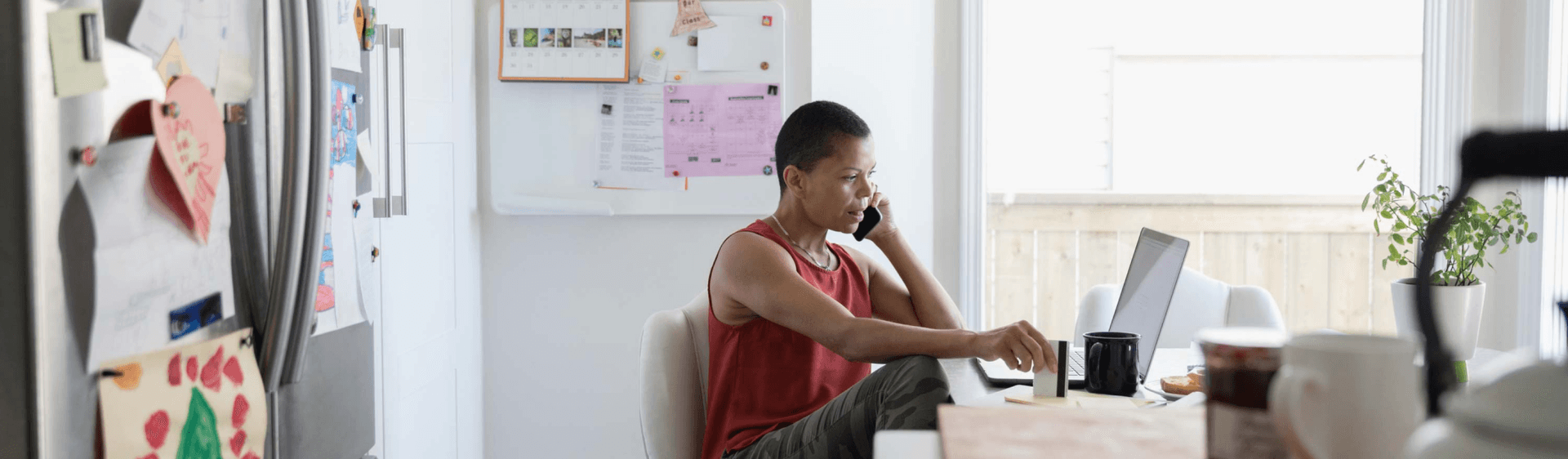 woman on the phone in front of laptop