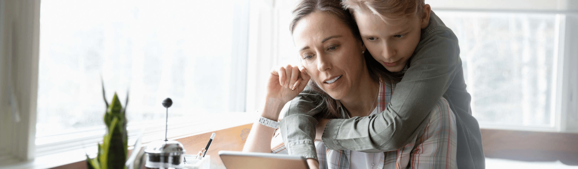 mother and son looking at iPad